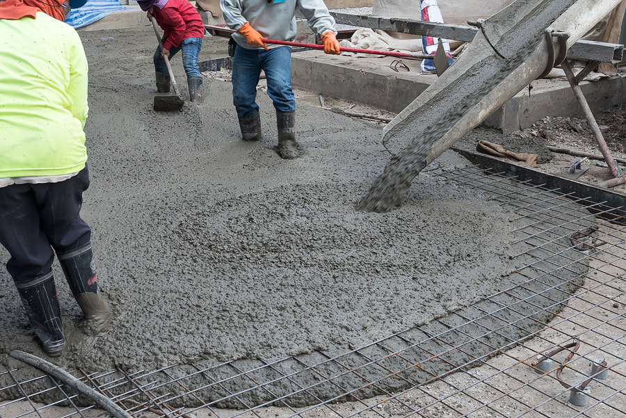 men putting mixed cement